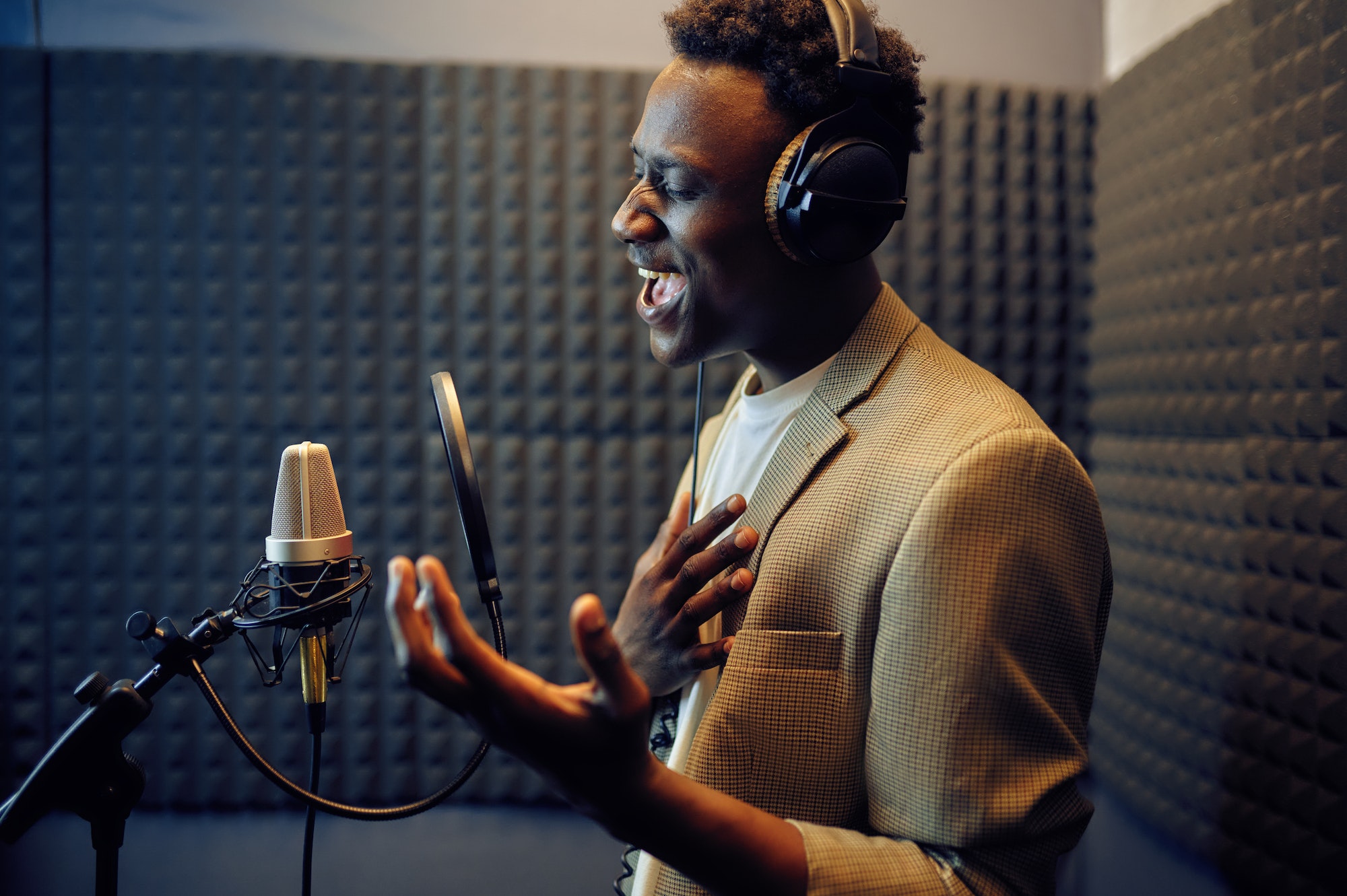 Male singer sings a song, recording studio